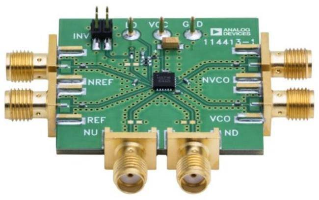 A green electronic circuit board with golden connectors and various components, including a black chip in the centre.