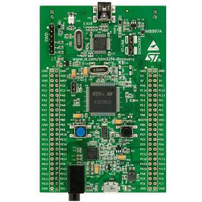 A green microcontroller development board with numerous ports and a central processor chip. A USB port is visible at the top.