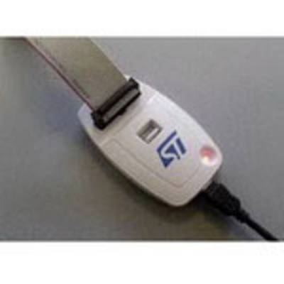 A white electronic device with a strap and a USB port, lying on a grey surface.
