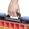 A hand is holding the handle of a toolbox with coloured compartments.