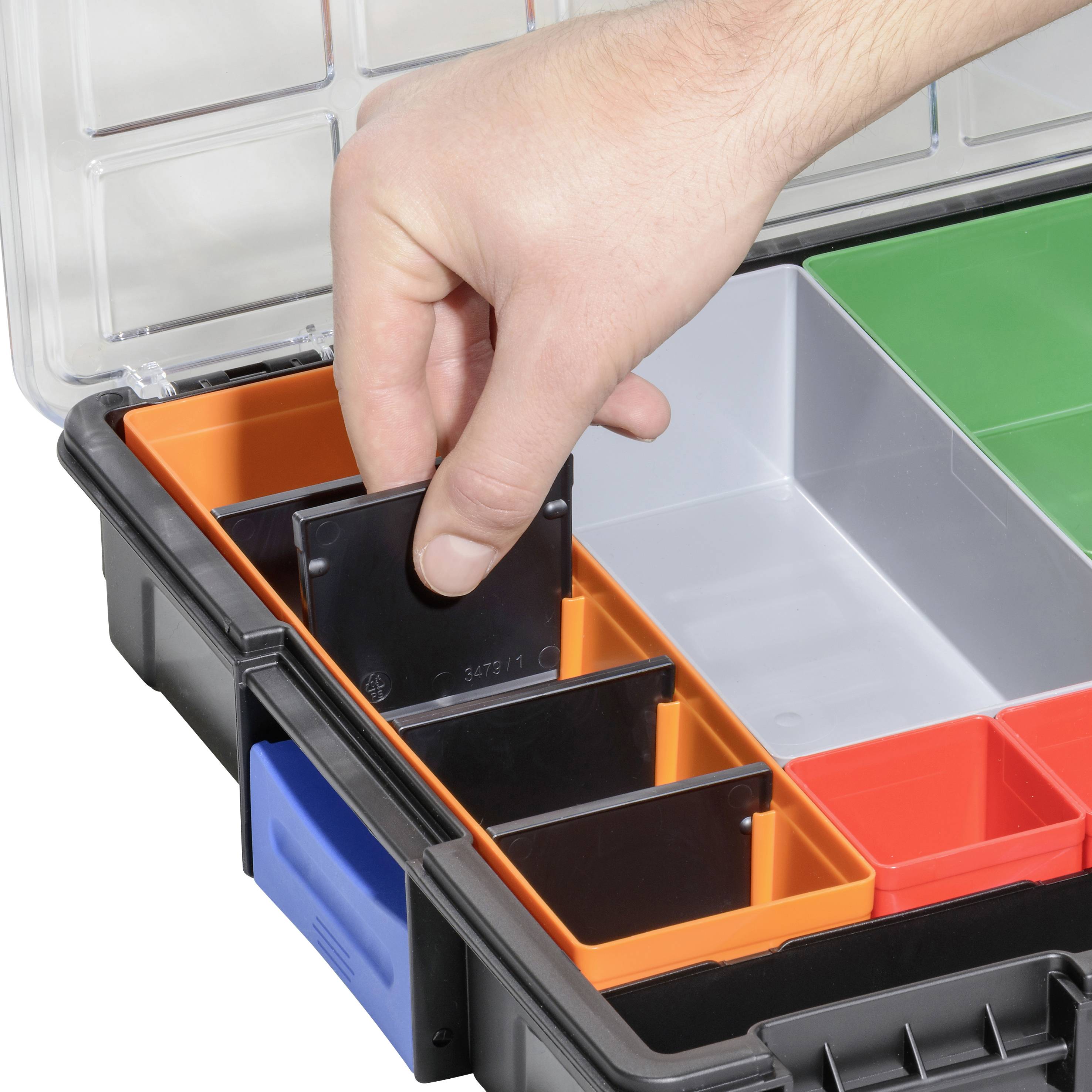 A hand reaches into a plastic box with various coloured compartments for organising small tools or accessories.