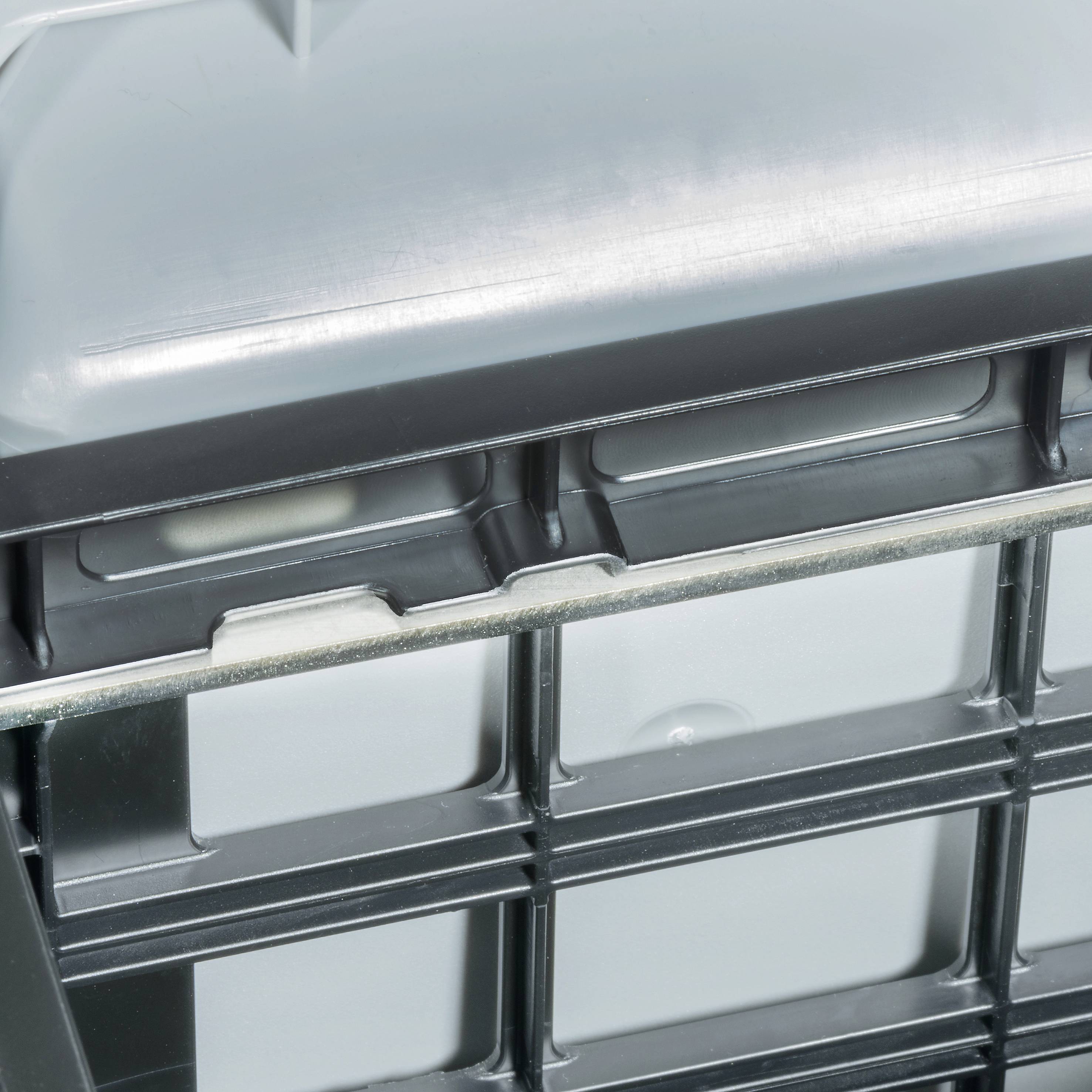 A grey plastic container with metal reinforcement, slightly curved at the top.