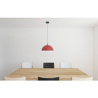 Minimal dining room with a wooden table, mixed chairs, and a red pendant light against plain white walls.