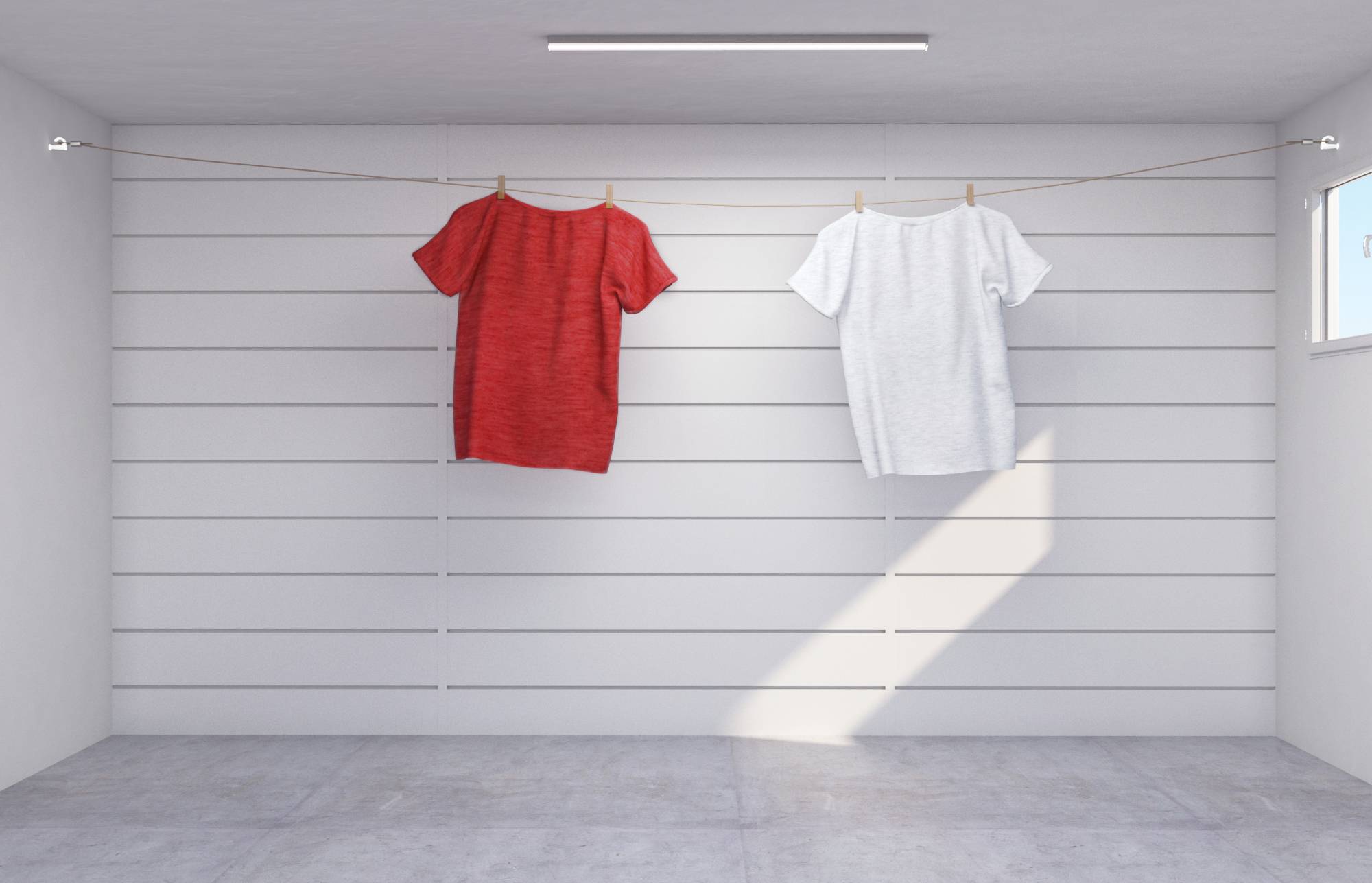Two T-shirts, red and white, are hanging on a washing line in a plain, white room with a small window on the right.