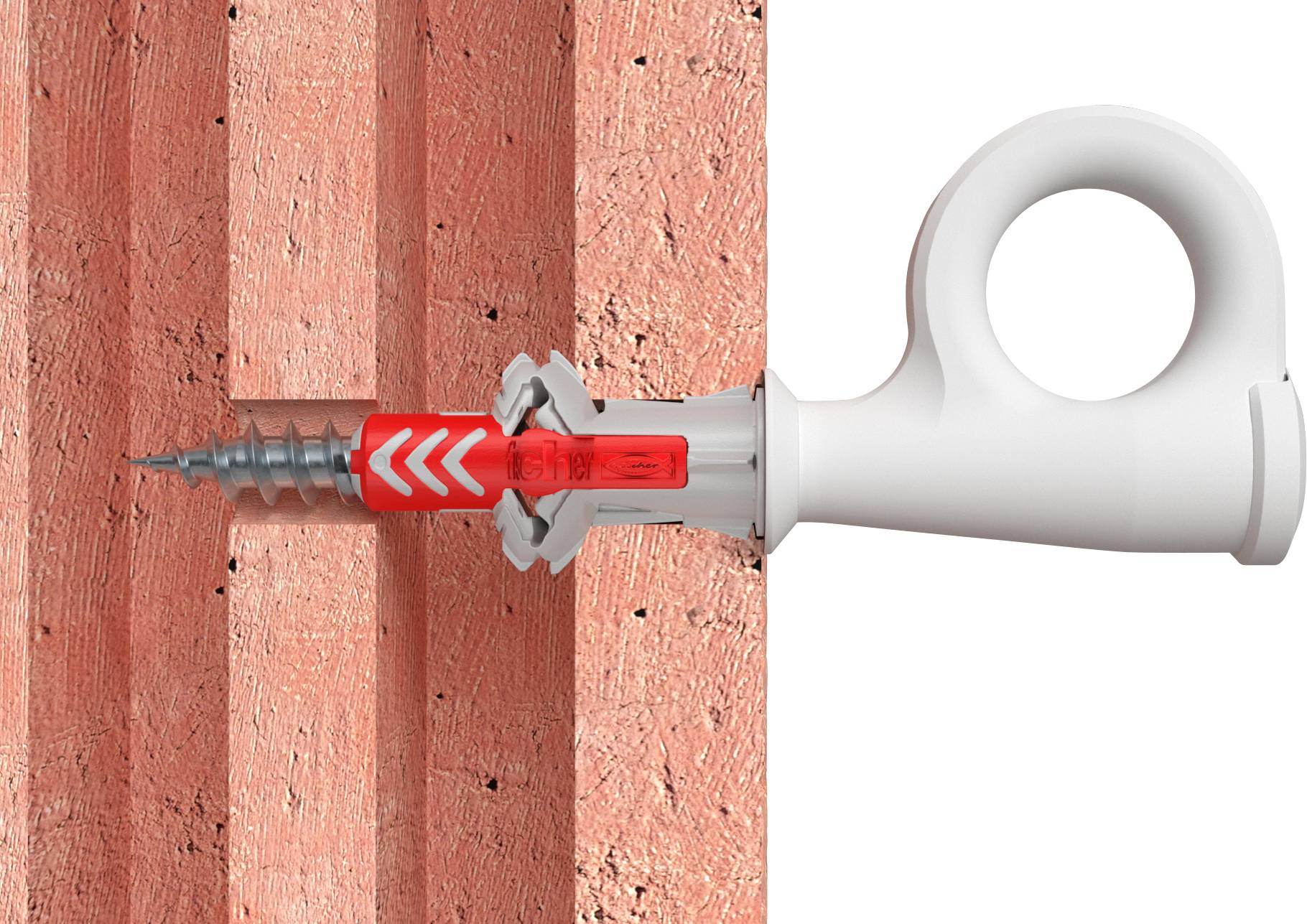 A wall plug is screwed into a brick wall. The wall plug is red and white with a screw in the centre.
