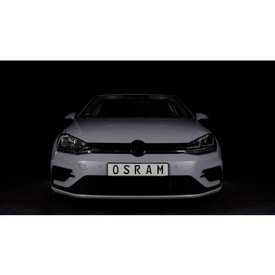A white car is parked in a dark room. The number plate reads 'OSRAM'. The car is depicted from a frontal view.