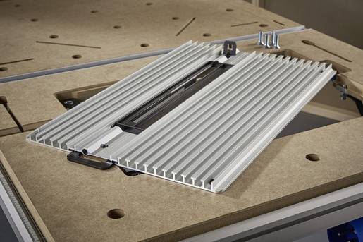 Rectangular insert base with a ribbed surface, built into a wooden table. Suitable for machines or tools.