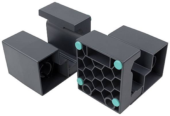 Two black plastic blocks with a honeycomb pattern and green dots on the top surface, possibly designed as stackable elements.