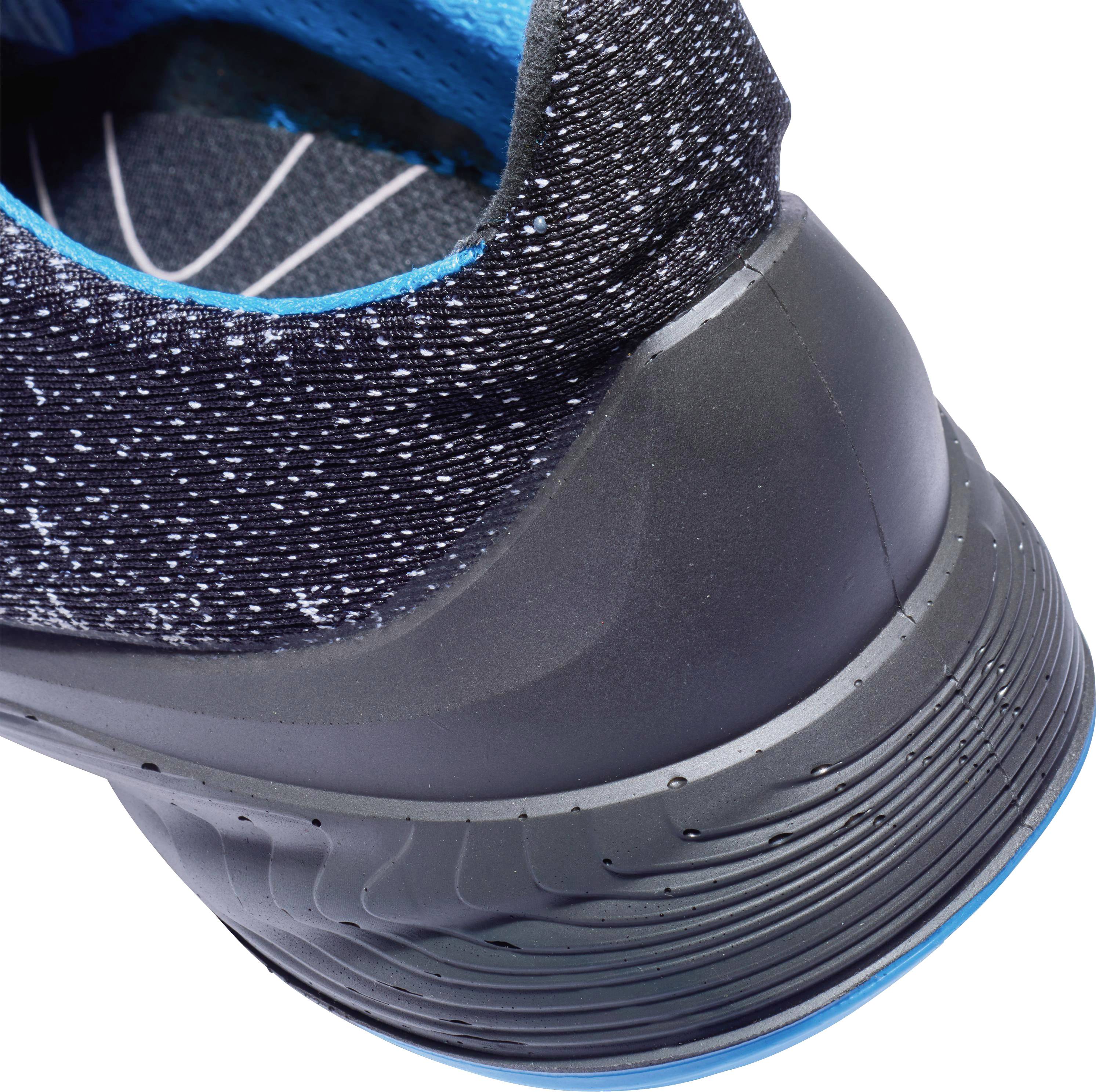 A modern sports trainer with dark grey upper material, blue accents, and a structured sole pattern.