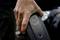 A hand is holding an electric bicycle battery. A charging indicator with a circular diagram is displayed on the battery.