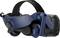 A navy-blue virtual reality headset with padded earphones and an adjustable headband.