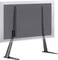 A black TV stand with two long legs is mounted on a transparent screen.