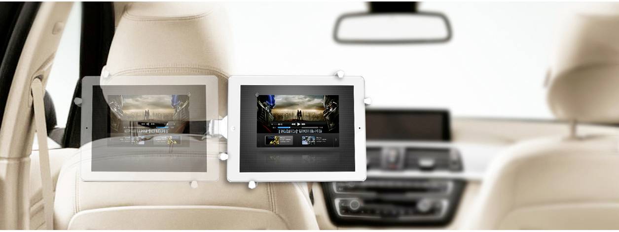 Tablets at the back of car seats, playing different films. Car interior visible in the background.