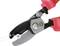 Wire cutters cutting a thin cable. Close-up of the cutting tool with red handles.
