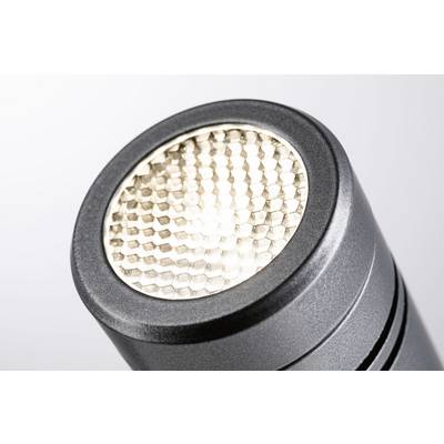 Close-up of an illuminated LED torch with a honeycomb-shaped lens against a light grey background.