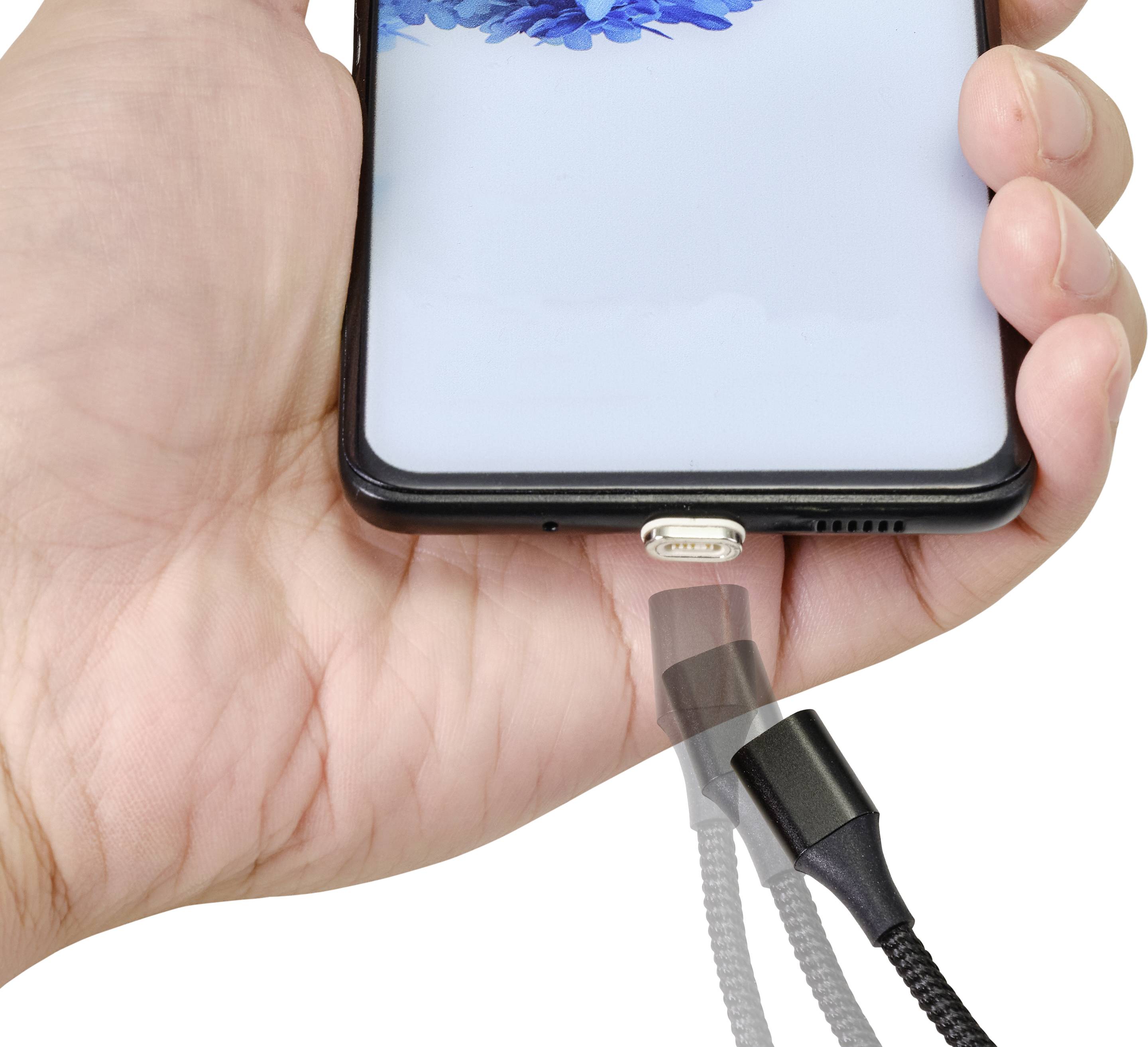 A smartphone is being held in hand; a charger approaches the charging port, indicating an impending charging process.