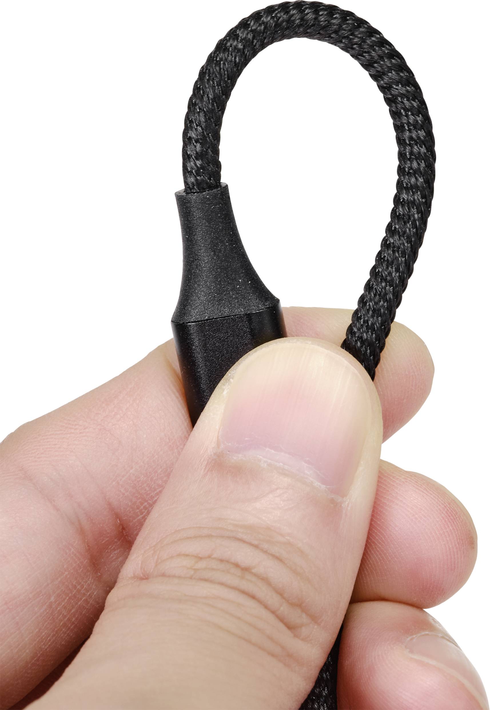 A hand holds a black, braided cable with a plastic sheath at one end.