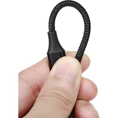 A hand holds a black, braided cable with a plastic sheath at one end.