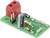 Electronic circuit board with capacitors, resistors, and a red connector, used for controlling and regulating electrical signals.