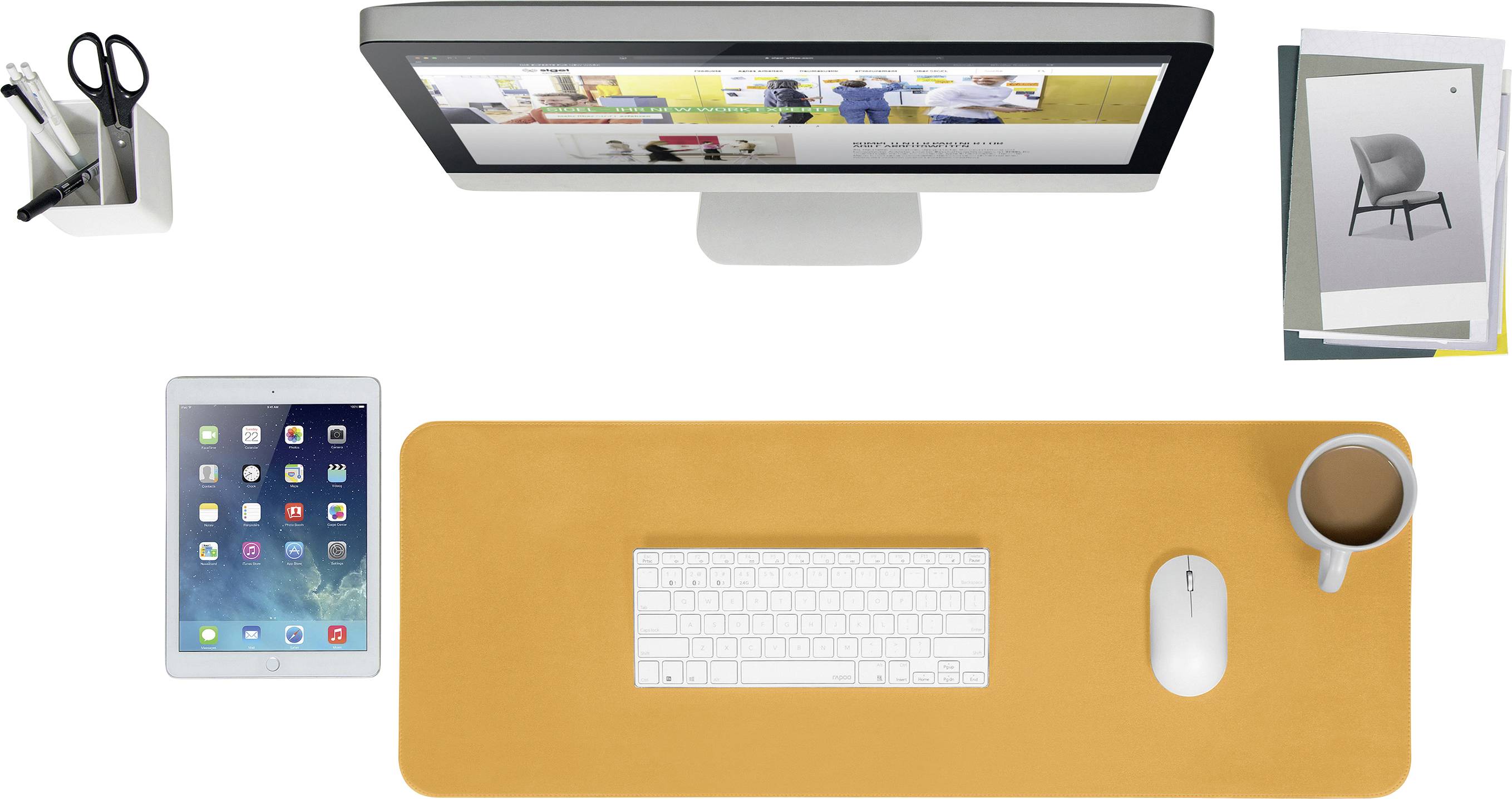 A desk with an orange mat displays a monitor, keyboard, mouse, tablet, pencil pot and a cup of coffee.