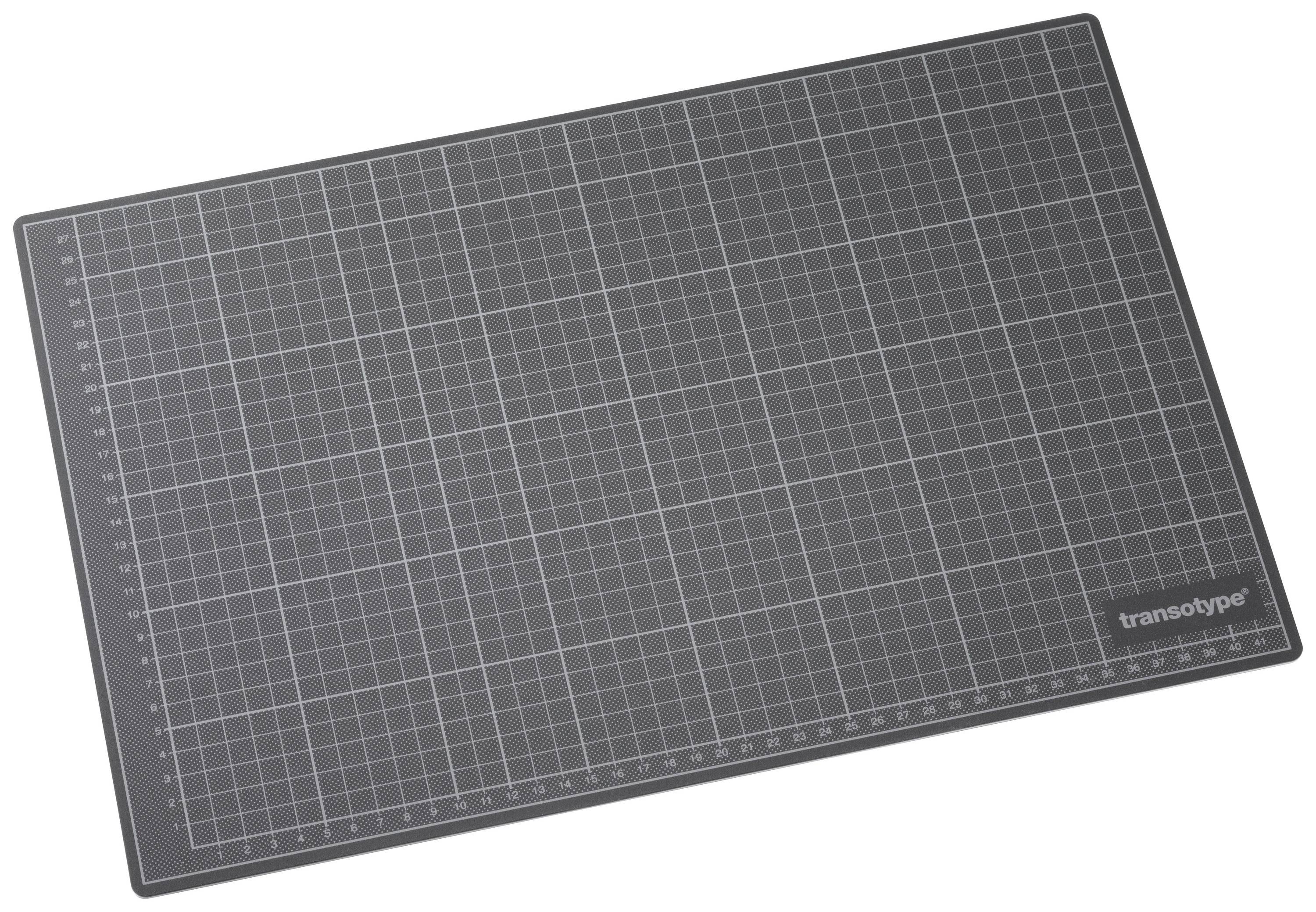 Grey cutting mat with grid lines and measurements from 0 to 45 cm along the edges. 'Transotype' marking in the bottom right corner.