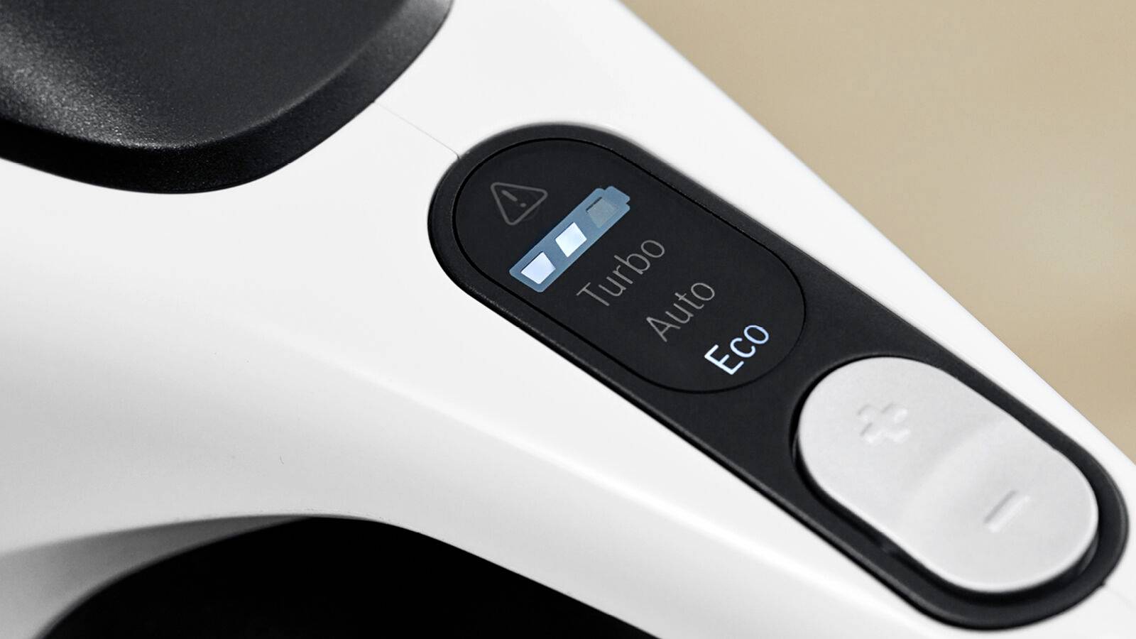 Close-up of a vacuum cleaner with control panel. It shows three settings: 'Turbo', 'Auto' and 'Eco'. Battery level indicator visible.