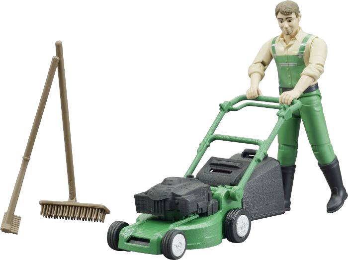 A miniature figurine of a gardener in green clothing is pushing a lawnmower. Beside it stands a brown rake.