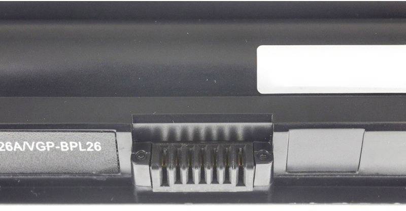 'Black laptop battery with white label and connection pins, which provide power to the device.'