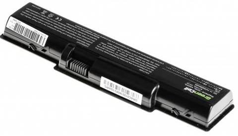 A black laptop battery is lying on a white surface. Technical information and a barcode are visible on the battery.