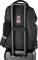 A black rucksack with a red logo, attached to a wheeled suitcase. The adjustable shoulder straps and the suitcase handles are visible.