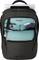 A black rucksack with multiple compartments. The front compartment contains small items and the larger compartment holds a laptop.