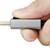 A hand is holding a silver USB-C plug, ready to be inserted.