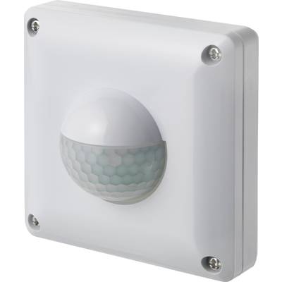 A white motion sensor on the wall, with a semi-spherical, honeycomb-like lens in the centre for detecting movement.
