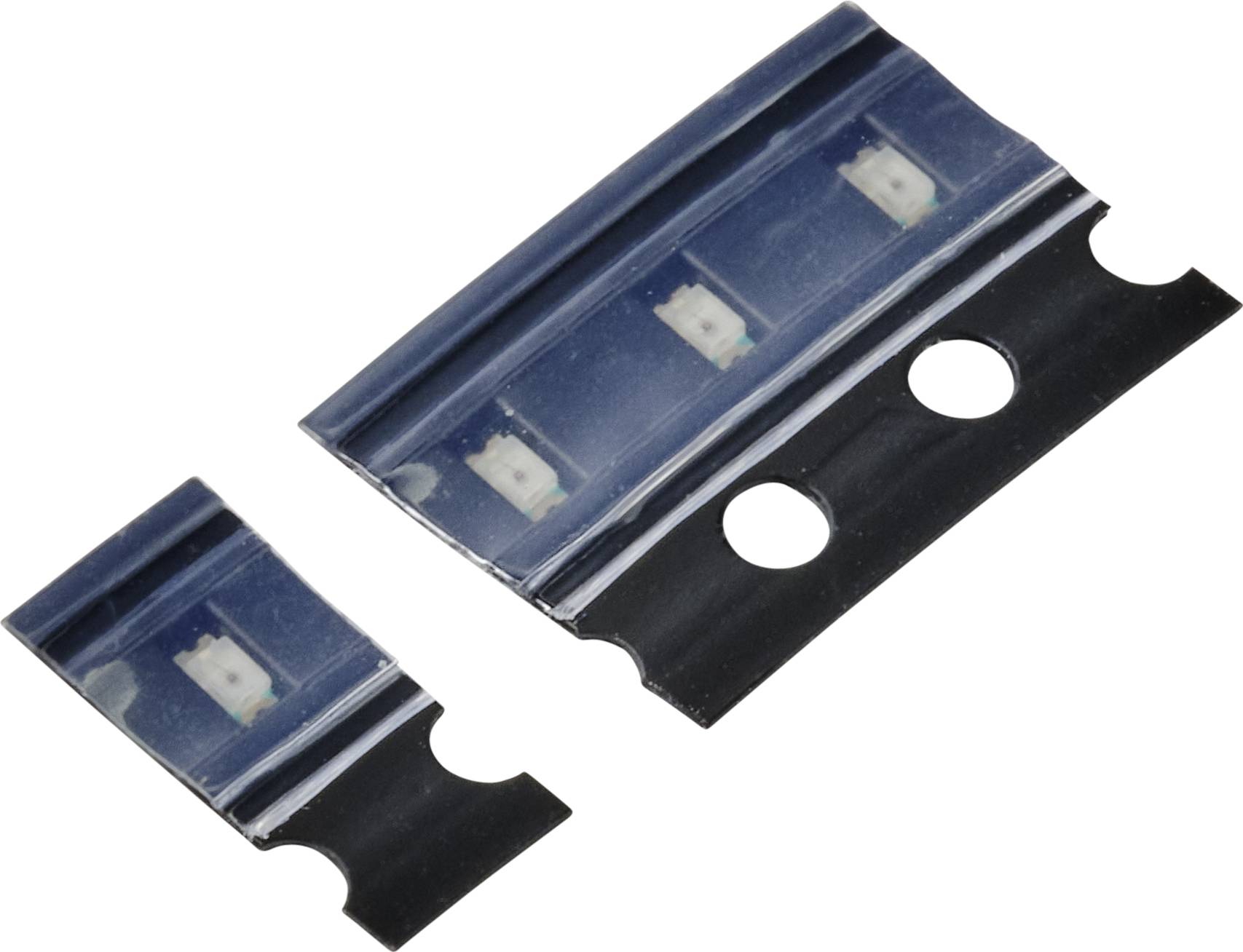 Two blue electronic components on a black carrier tape, commonly used in electronics manufacturing, against a neutral background.