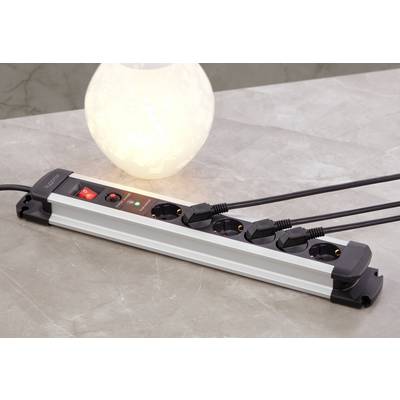 A multi-socket extension lead with five occupied plug sockets and an illuminated night light sitting on a table.