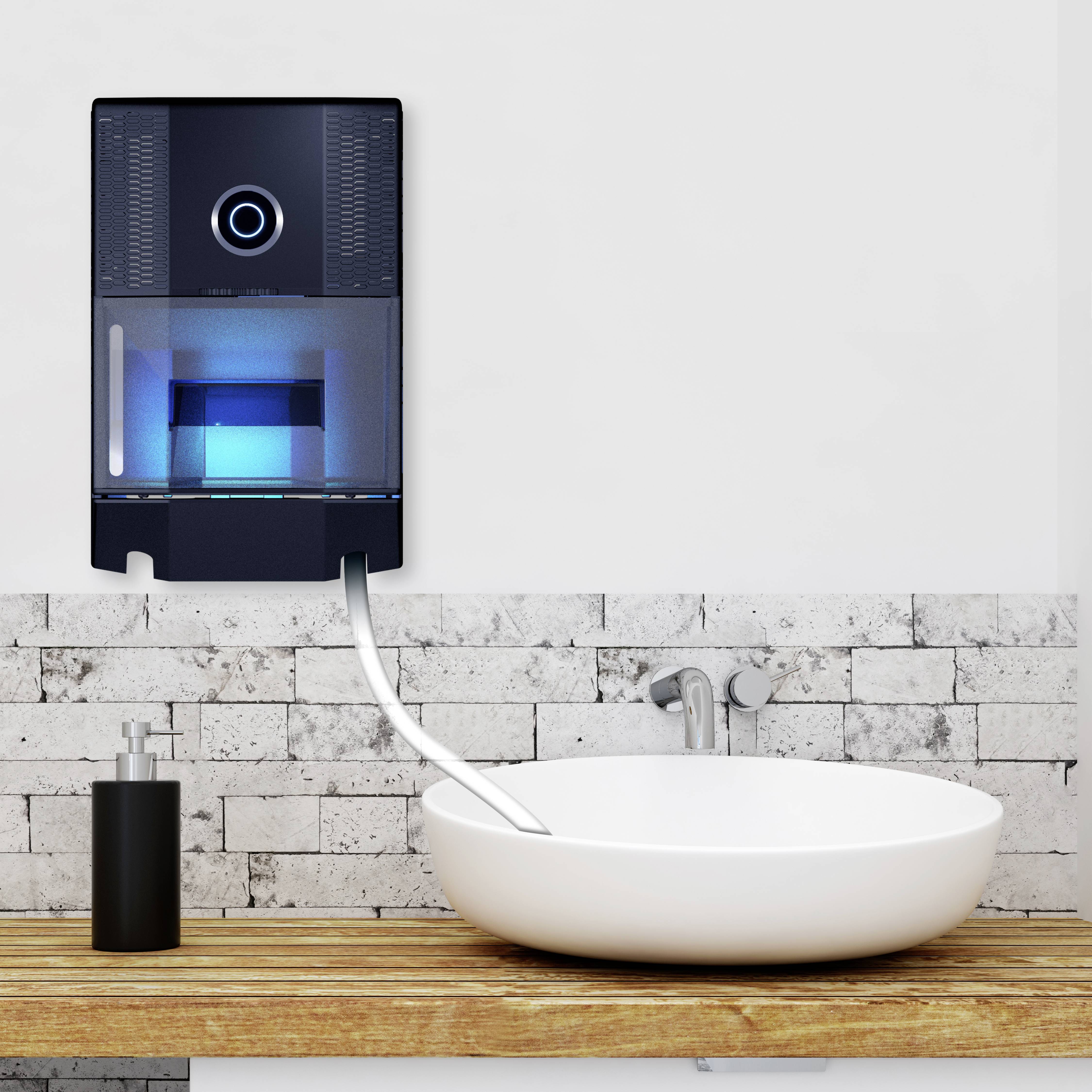 Black soap dispenser mounted on a white wall above stone tiles and a washbasin, connected by a hose. Modern bathroom aesthetic.