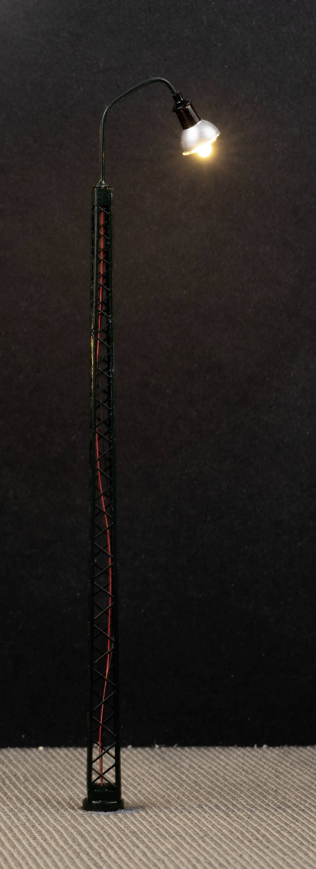 A lit street lamp against a dark background.