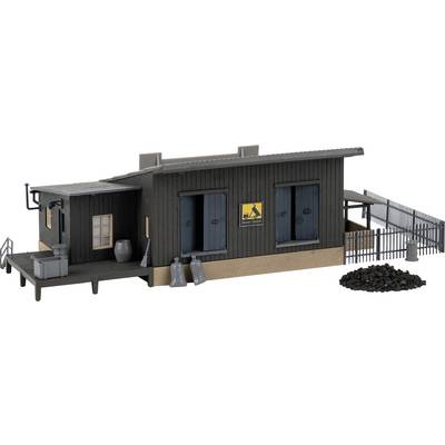 A model of a coal storage warehouse with two blue doors, a railing, and a pile of coal beside it. A sign displays a cart symbol.