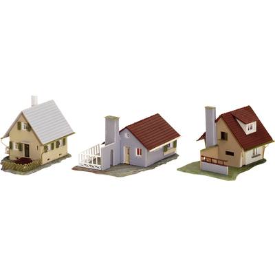 Three miniature houses in model-building style: a yellow house with a chimney, a grey one with a red roof, and a beige one with a balcony.