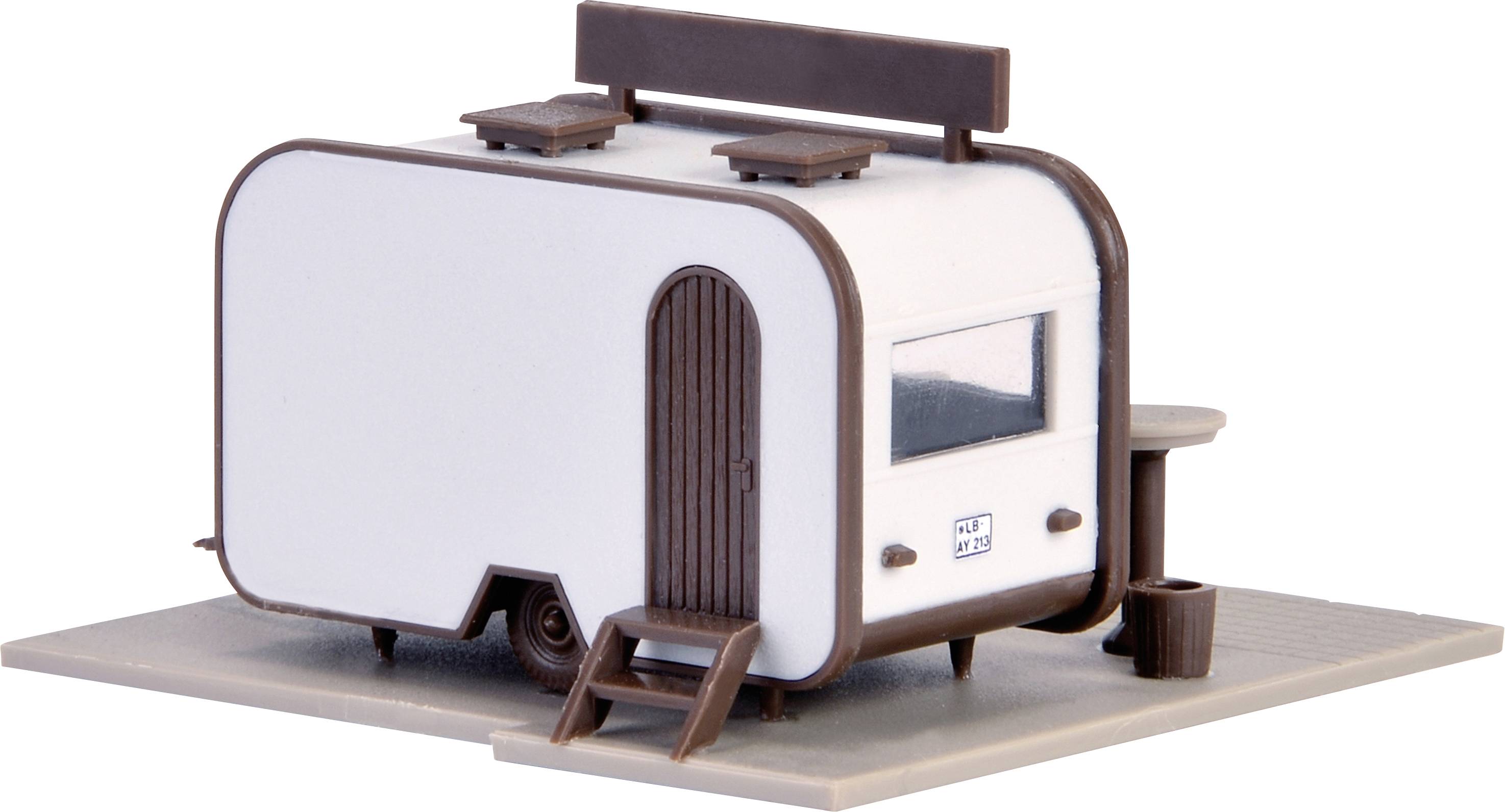 A small model of a caravan with brown accents and a step, positioned on a rectangular base.