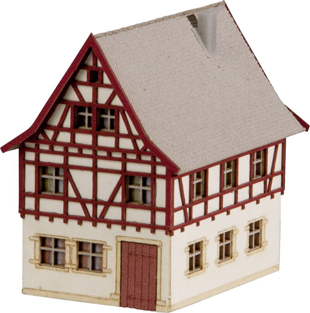 Model of a traditional half-timbered house with red timbers and roof. Four windows at the front, entrance door on the ground floor.