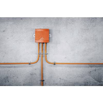 An orange distribution box mounted on a grey wall, with cables running sideways and downwards. Minimalist industrial design.