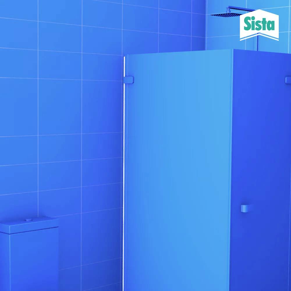 Blue bathroom with shower, tiled wall and a bin. A 'Sista' logo is visible in the top right corner.