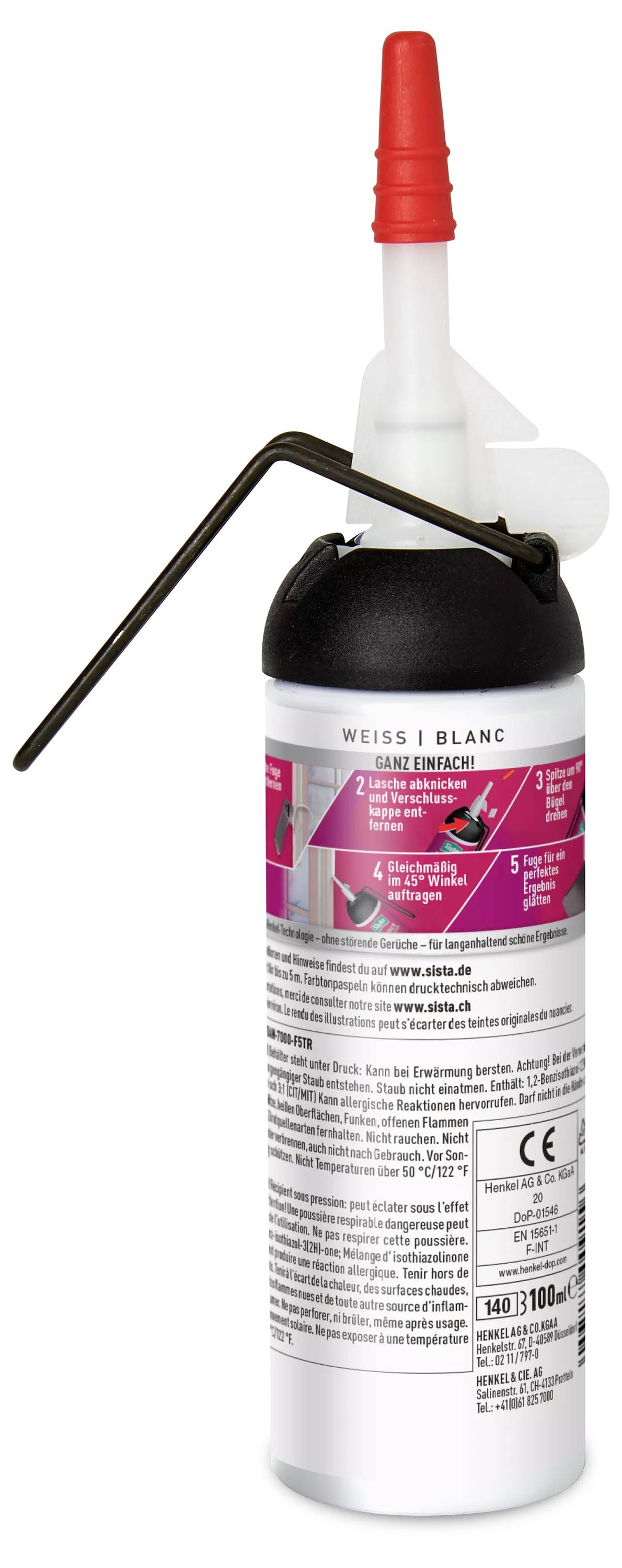 Ink cartridge with red nozzle and instruction manual on the bottle.