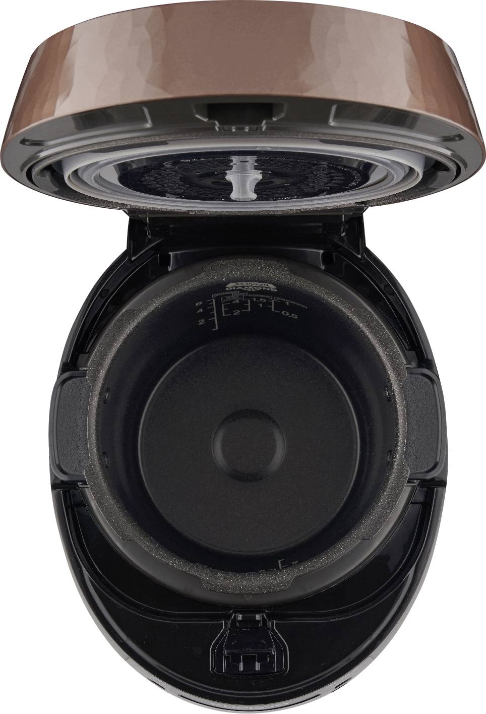 A opened electric rice cooker, viewed from above, shows the inner pot with measurement markings on the wall.