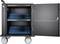 Black, open trolley with two shelves full of blue tablet compartments, equipped with locks and large wheels.