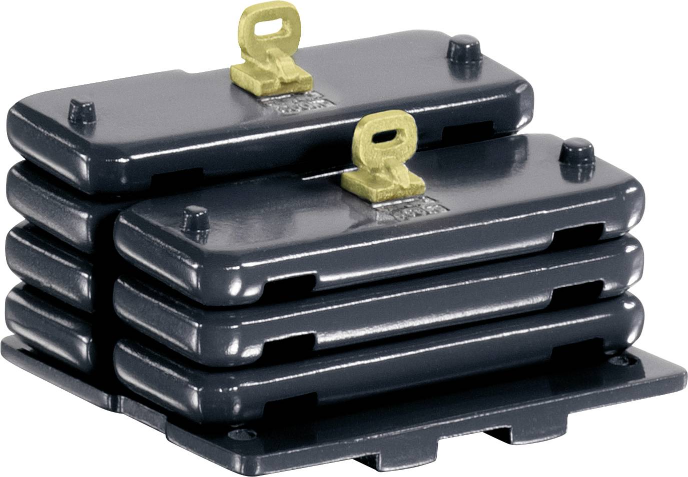 'Stack of four dark, rectangular metal plates with rounded corners and two yellow keys on top.'