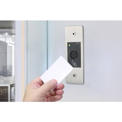 A hand holds a card up to an access control system on a wall. A green light indicates successful authorisation.