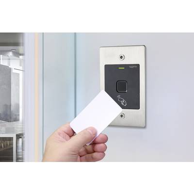 A hand holds a card up to a modern access control system on an office door. The system displays a bookmark and a light.