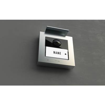 Silver intercom system on a wall, with a large display and camera. The display shows 'NAME'.